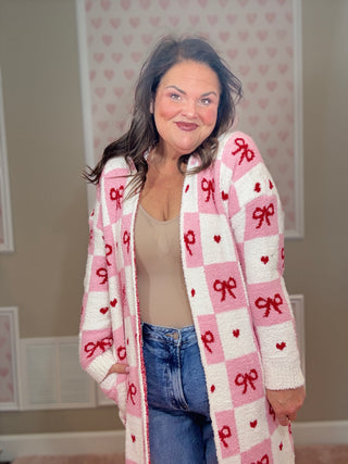 Valentine’s edition cloud cardigan for women featuring ultra-soft cozy fabric with a checkered pattern and bow details, perfect for comfy mom style and chic mom-approved looks.