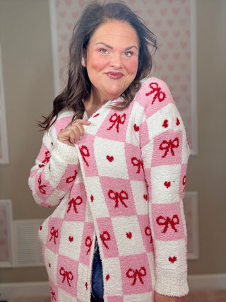 Valentine’s edition cloud cardigan for women featuring ultra-soft cozy fabric with a checkered pattern and bow details, perfect for comfy mom style and chic mom-approved looks.
