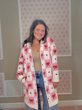Valentine’s edition cloud cardigan for women featuring ultra-soft cozy fabric with a checkered pattern and bow details, perfect for comfy mom style and chic mom-approved looks.