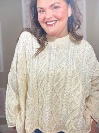 Woman wearing a slouchy ombre cable knit sweater styled with denim for chic mom-approved looks and trendy clothes.