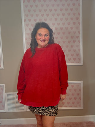 Woman wearing a crimson rounded bottom luxury sweatshirt styled with leggings or denim for chic mom-approved looks and trendy clothes.
