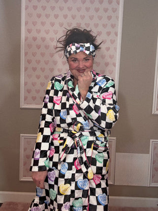 Checkered conversation hearts spa headband featuring a soft plush fabric and Valentine-inspired heart design, perfect for self-care routines and women’s accessories.