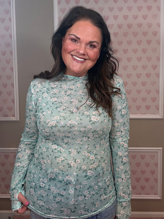 Lightweight sage floral mesh layering top with thumbhole sleeve detail styled for comfy mom style spring outfit.