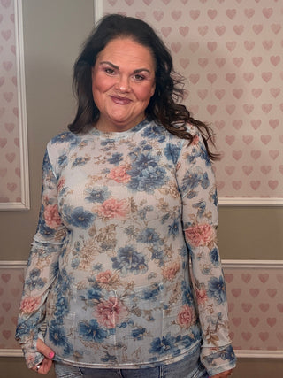 Woman wearing blue floral mesh long sleeve top with sheer stretch fabric and romantic English garden print styled with casual outfit.