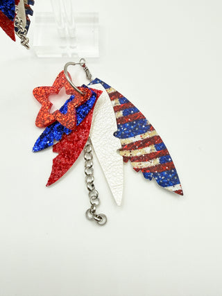 Colorful feather keychain with star design on a white background