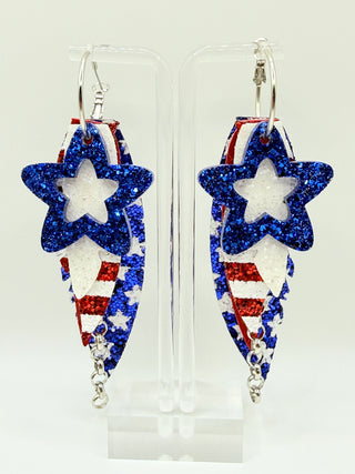 Pair of earrings with star designs in red, white, and blue on a clear background