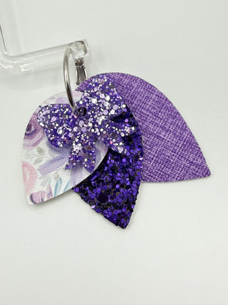 Purple glittery fish-shaped object on a glass with a white background