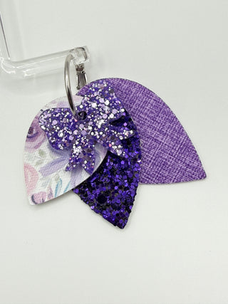 Purple glittery hair clip on a white background