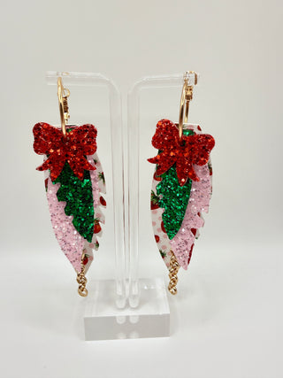 Layered strawberry print statement earrings with red glitter bow, pink sparkle accents, faux leather feather details, and rose gold chain charm.