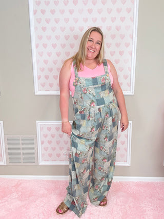 Person wearing a floral overalls with a patterned background