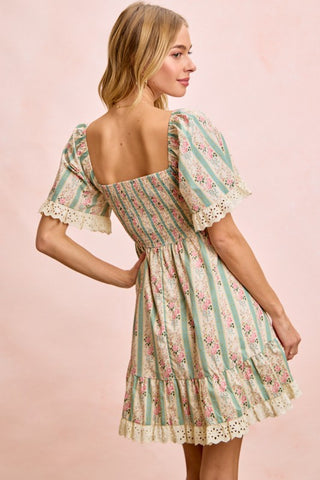 Woman wearing a floral dress with a pink background
