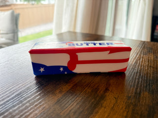 Squish Butter with American flag design on a wooden table
