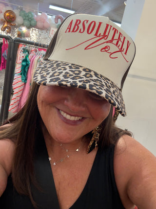 Person wearing a cap with 'Absolutely Not' text in a store setting