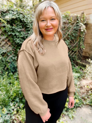 Woman wearing the Izzy Inside-Out Cropped Sweatshirt, styled casually for a bold, playful look.