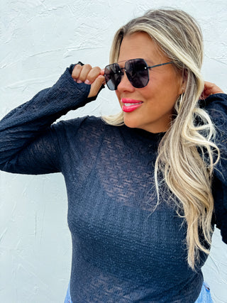Woman wearing the Juliette Lace Top, styled with a skirt or jeans for a chic, feminine look.