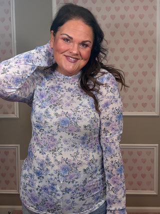 Lavender floral sheer mesh layering top with crew neckline and thumbhole sleeves styled for trendy women’s clothing look.