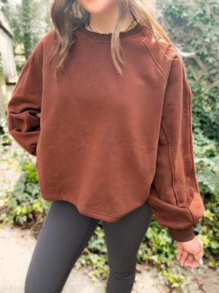 Woman wearing the Madeline Midi Balloon Sleeve Sweatshirt styled casually for a chic, comfortable look.