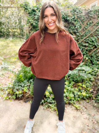 Woman wearing the Madeline Midi Balloon Sleeve Sweatshirt styled casually for a chic, comfortable look.