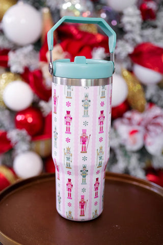 Tumbler with nutcracker design against a festive background