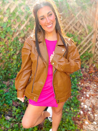 Woman wearing the Ollie Oversized Vegan Leather Biker Jacket, styled for an edgy, chic look with denim or skirts.