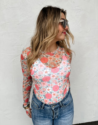 Woman wearing the Vintage Floral Mesh Top styled casually with jeans for a relaxed, chic look.