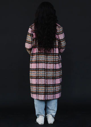 Woman wearing the Plaid Coat in Pink, Brown, & Black, styled with a chic outfit for a cozy, stylish winter look.