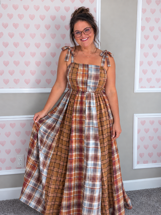 Blakeley Ashford Plaid Maxi Dress featuring warm autumn patchwork plaid, flattering square neckline, adjustable tie straps, smocked back, and flowy full-length skirt, available in women's sizes S/M–3X.