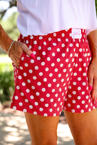 Red and white polka dot boxer shorts with elastic waistband, side pockets, and relaxed fit by Jess Lea. 