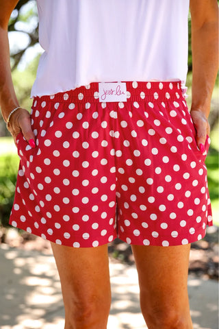 Red and white polka dot boxer shorts with elastic waistband, side pockets, and relaxed fit by Jess Lea. 