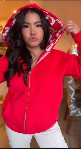 Woman wearing the Lina Oversize Checker Heart Silk Rose Gold Full Zip Hoodie, styled casually for a chic, luxe look.