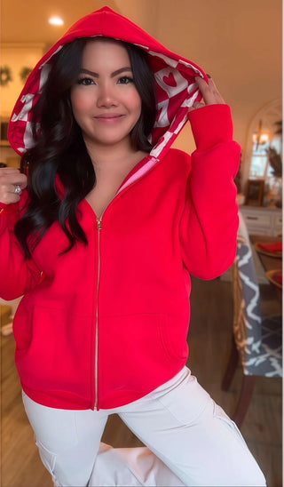 Woman wearing the Lina Oversize Checker Heart Silk Rose Gold Full Zip Hoodie, styled casually for a chic, luxe look.