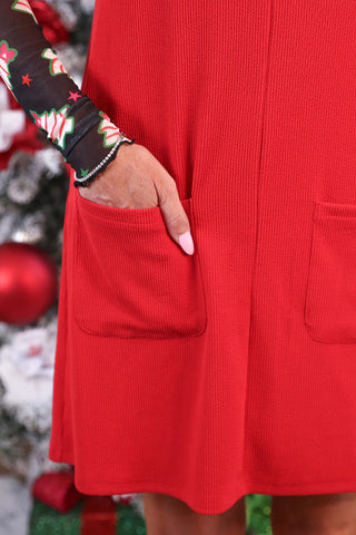 Close up of Cozy red ribbed jumper dress layered with a black mesh top, perfect comfy mom style.