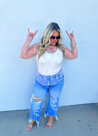 Woman wearing the Roxy Lace Top, styled for a feminine, elegant look.