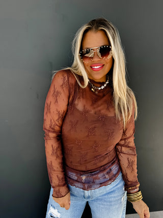 Woman wearing the Roxy Lace Top, styled for a feminine, elegant look.