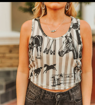 Person wearing a tank top with horse and music note patterns.