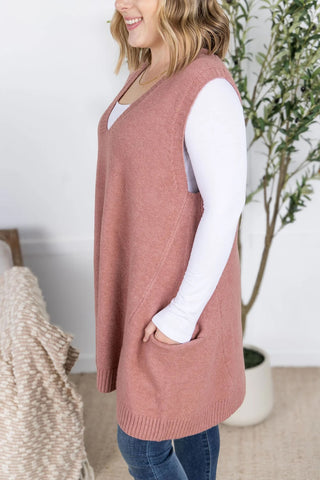 Close-up of the soft ribbed knit texture and pocket detail on the rose sweater vest.