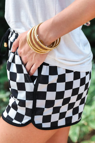 Side-up of the checkerboard pattern and drawstring waist on the soft, comfortable fabric of the Checkerboard Shorts.