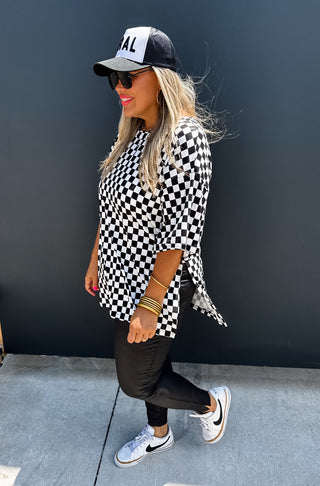 Woman wearing the Check Me Out Side Split Top, styled casually with jeans or a skirt for a trendy, laid-back look.