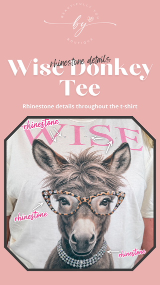 A pink promotional graphic for a t-shirt featuring a donkey wearing rhinestone glasses and a rhinestone necklace, with the text 'Wise Donkey Tee' and 'Rhinestone details throughout the t-shirt.'.