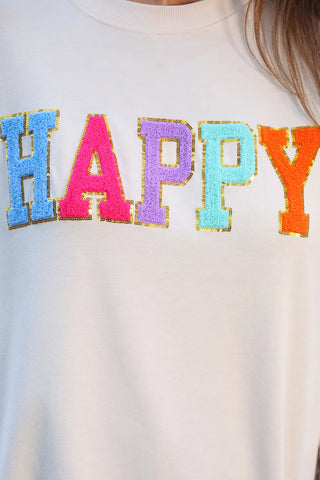 Close-up of ribbed hem and happy patch detail on the pullover—lightweight and comfy for everyday wear.