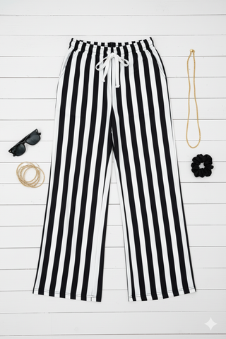 Soft, stretchy wide-leg pants with vertical stripes, elastic waistband with faux drawstring, and side pockets — flattering and comfy everyday style.