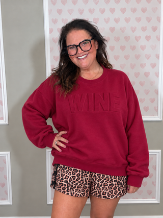 Woman wearing the Wine Embossed Sweatshirt, styled casually for a cozy, chic look.
