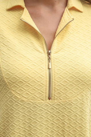 Butter yellow textured women’s dress featuring functional front zipper detail and soft stretchy A-line fit, perfect for trendy spring fashion.
