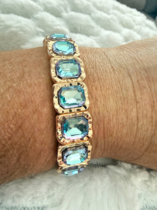 Gold stretch bracelet with faceted crystal gemstones available in multiple colors.