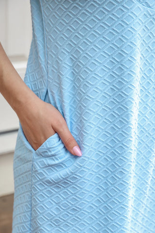 Light blue textured women’s dress featuring functional front zipper detail and soft stretchy A-line fit, perfect for trendy spring fashion.