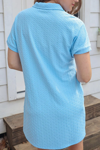 Full-length view of light blue A-line dress with textured fabric and zipper neckline, styled with sandals for effortless comfy mom style look.