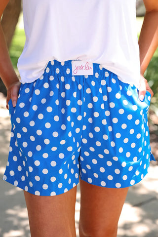 Blue and white polka dot boxer shorts with elastic waistband, side pockets, and relaxed fit by Jess Lea. 