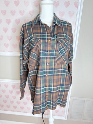 Oversized brown plaid flannel shirt with teal and cream accents button front and relaxed fit for cozy fall layering