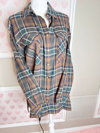 Oversized brown plaid flannel shirt with teal and cream accents button front and relaxed fit for cozy fall layering