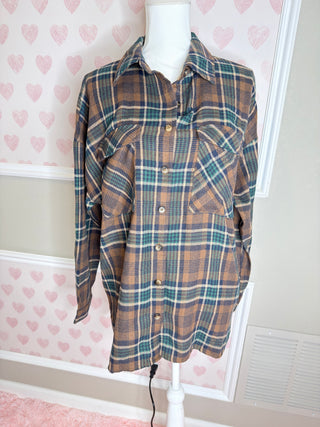 Oversized brown plaid flannel shirt with teal and cream accents button front and relaxed fit for cozy fall layering